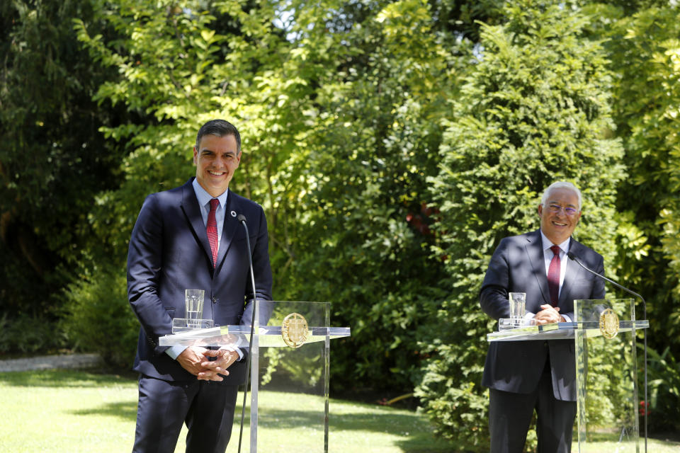 Spain's Prime Minister Pedro Sanchez, left, and Portugal's Prime Minister Antonio Costa smile during a news conference following their meeting at the Sao Bento palace in Lisbon, Monday, July 6, 2020. (AP Photo/Armando Franca)