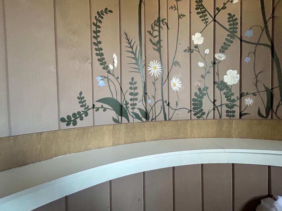 flowers painted on paneled wall  in Rapunzel's Cottage