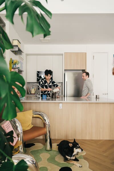 Mikei and his partner photographed in their kitchen area.