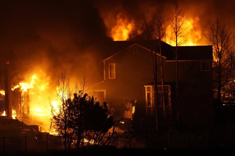 FILE - Homes burn as a wildfire rips through a development, Dec. 30, 2021, in Superior, Colo. Authorities say they have wrapped up their investigation into what started the most destructive wildfire in Colorado history and will announce their findings on Thursday, June 8, 2023. (AP Photo/David Zalubowski, File)