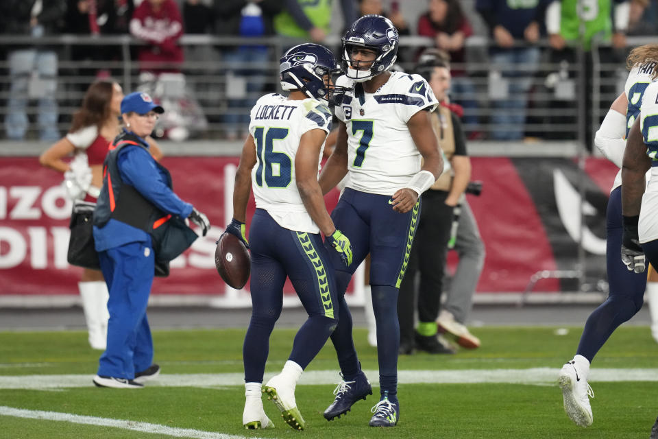 Seattle Seahawks wide receiver Tyler Lockett (16) celebrates with quarterback Geno Smith (7) after Lockett caught a two-point conversion against the Arizona Cardinals in the fourth quarter of an NFL football game Sunday, Jan. 7, 2024, in Glendale, Ariz. Lockett caught a 34-yard touchdown pass on the previous play. The score gave the Seahawks a 21-20 win. (AP Photo/Ross D. Franklin)