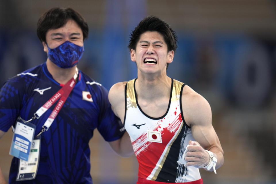 Daiki Hashimoto, of Japan, celebrates his performance on the horizontal bar during the artistic men's team final at the 2020 Summer Olympics, Monday, July 26, 2021, in Tokyo. (AP Photo/Natacha Pisarenko)