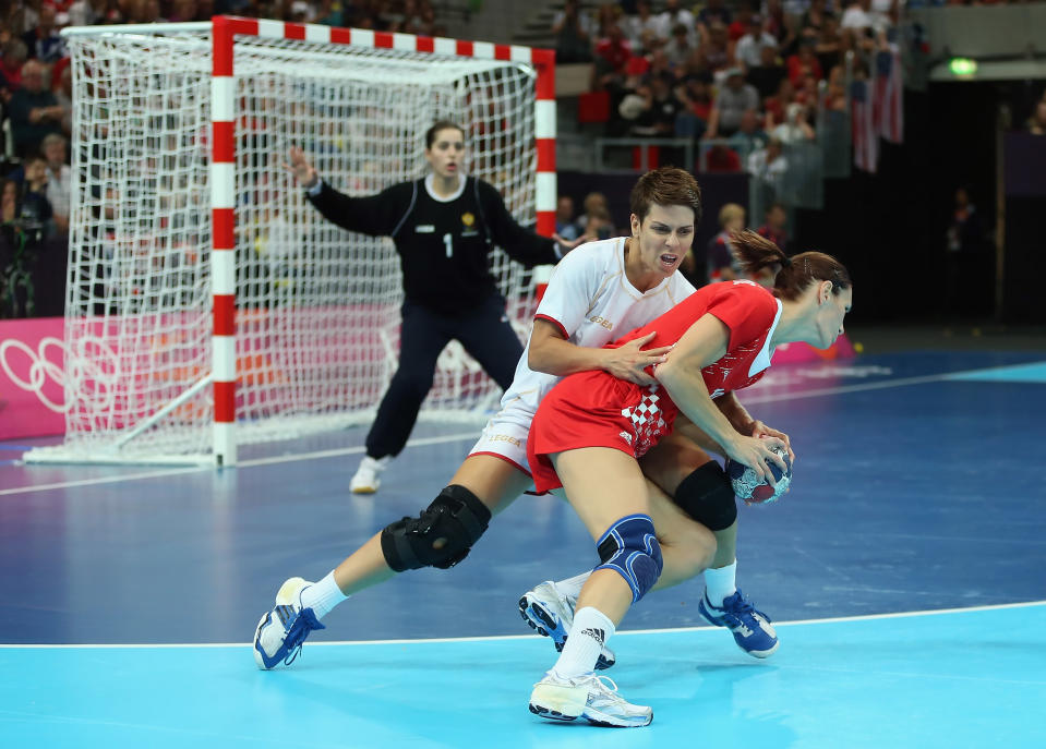 LONDON, ENGLAND - AUGUST 03: Nikica Pusic-Koroljevic (R) #10 of Croatia is defended by Ana Dokic #5 of Montenegro during the Women's Handball Preliminaries Group A match between Croatia and Montenegro on Day 7 of the London 2012 Olympic Games at Copper Box on August 3, 2012 in London, England. (Photo by Jeff Gross/Getty Images)