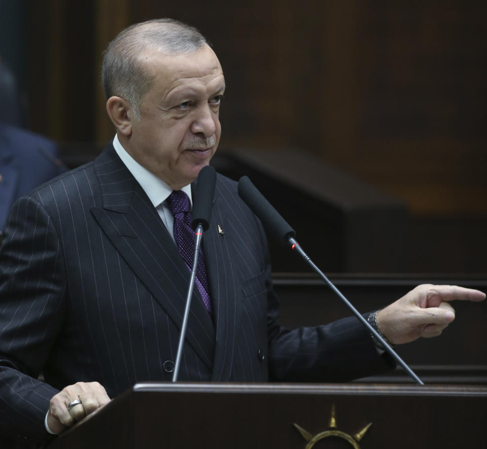 Turkish President Recep Tayyip Erdogan addresses the mmbers of his ruling party at the parliament, in Ankara, Turkey, Wednesday, Oct. 14, 2020. Erdogan on Wednesday accused Greece and Cyprus of failing to fulfill "promises" made during negotiations within the European Union and NATO and said his country would continue to give them "the response they deserve". (Turkish Presidency via AP, Pool)