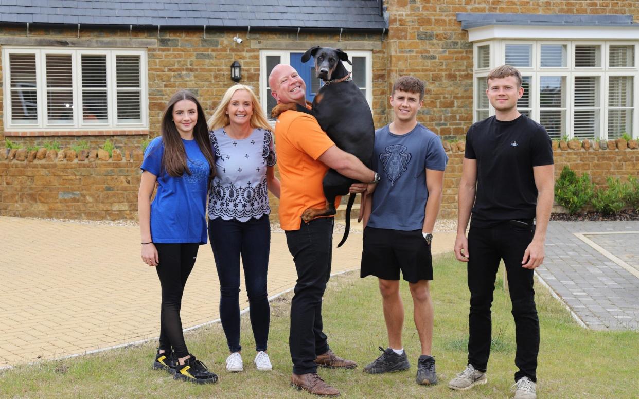 Steve Cummings and dog Bella photographed with his family (L-R) Saskia, Claire, Hayden and Bradley at their home near Banbury in Oxfordshire. - John Lawrence 