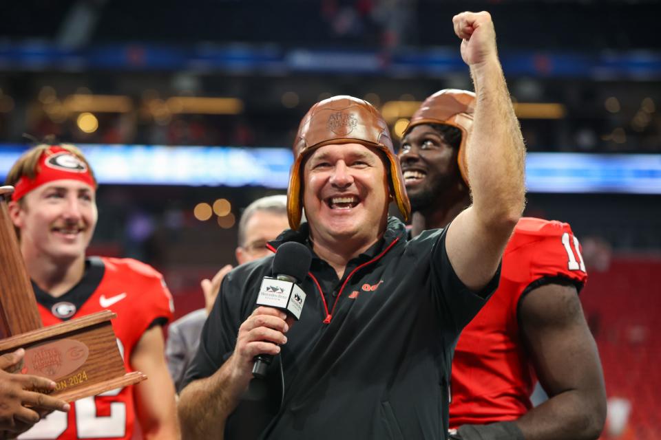 Georgia coach Kirby Smart wears the old leather helmet after the Bulldogs' victory over Clemson at Mercedes-Benz Stadium in Atlanta on Aug. 31, 2024.