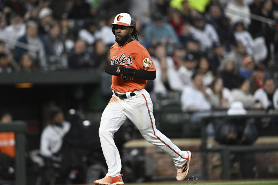 Baltimore Orioles' Cedric Mullins races home to score on a sacrifice fly hit by Anthony Santander in the first inning of a baseball game against the New York Yankees, Saturday, April 8, 2023, in Baltimore. (AP Photo/Gail Burton)