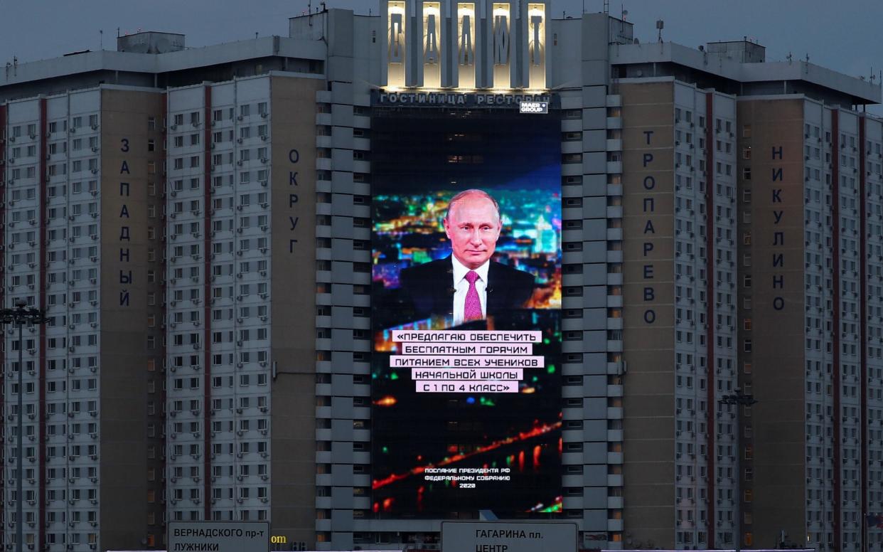 A screen shows Mr Putin's address to the Federal Assembly in Moscow - REUTERS