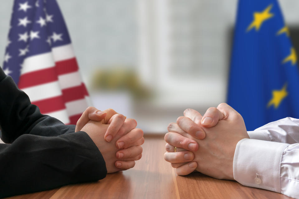 Negotiation of USA and European Union. Statesman or politicians with clasped hands.