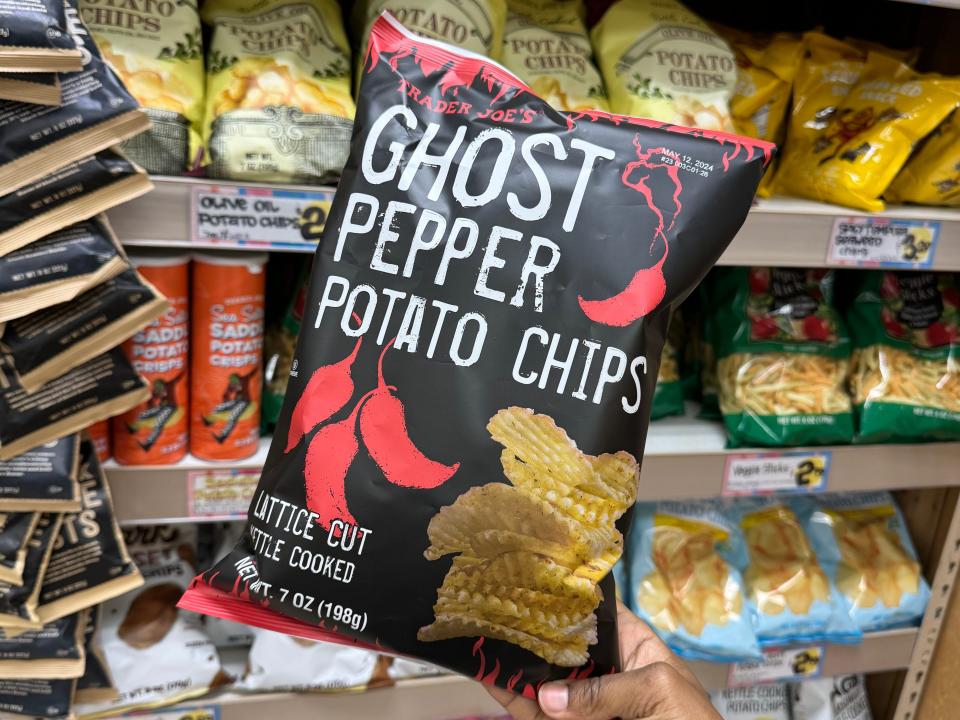 hand holding up a bag of ghost pepper potato chips at trader joes