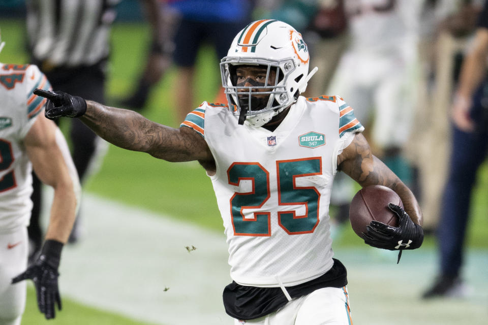 Miami Dolphins cornerback Xavien Howard (25) points and runs with the ball after intercepting a pass from Los Angeles Chargers quarterback Justin Herbert (not shown) during an NFL football game, Sunday, Nov. 15, 2020, in Miami Gardens, Fla. Howard leads the NFL this season with seven interceptions, and his shutdown skills have helped the Dolphins flummox foes with a blitz-happy scheme. (AP Photo/Doug Murray)