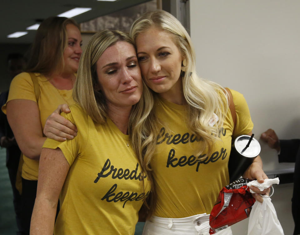 Heather Bash, left, and Jenny Hensley, right, who both oppose a measure that would give public health officials oversight of doctors that may be giving fraudulent medical exemptions from vaccinations console each after the bill, SB276, was approved by the Assembly Health Committee at the Capitol in Sacramento, Calif., Thursday, June 20, 2019. (AP Photo/Rich Pedroncelli)