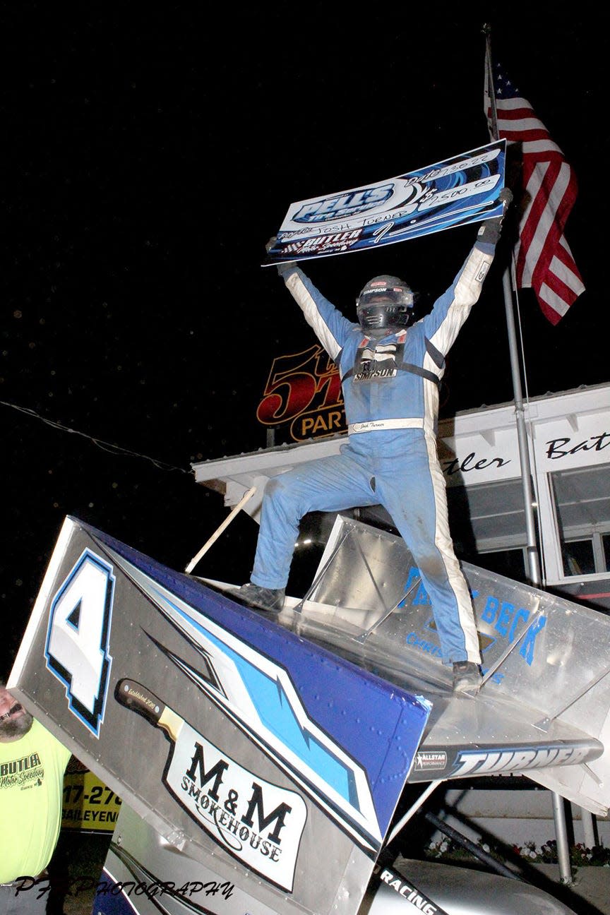 Josh Turner celebrates atop his car after picking up the $2,500 top prize in the Pell’s Tire Service 410 Winged Sprints race on Saturday