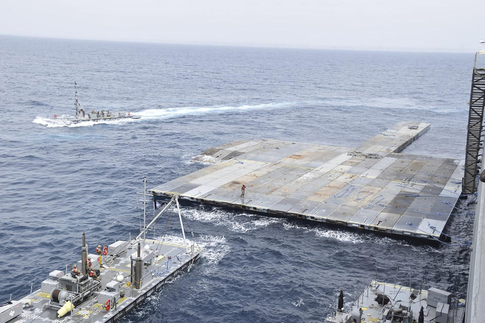 This undated photo released early Tuesday, April 30, 2024, by the U.S. military's Central Command shows construction off a floating pier in the Mediterranean Sea off the Gaza Strip. A U.S. Navy ship involved in the American-led effort to bring more aid into the besieged Gaza Strip is off shore from the enclave, slowly building out a floating platform for the operation, satellite photos analyzed Monday, April 29, 2024, by The Associated Press show. (U.S. military's Central Command via AP)