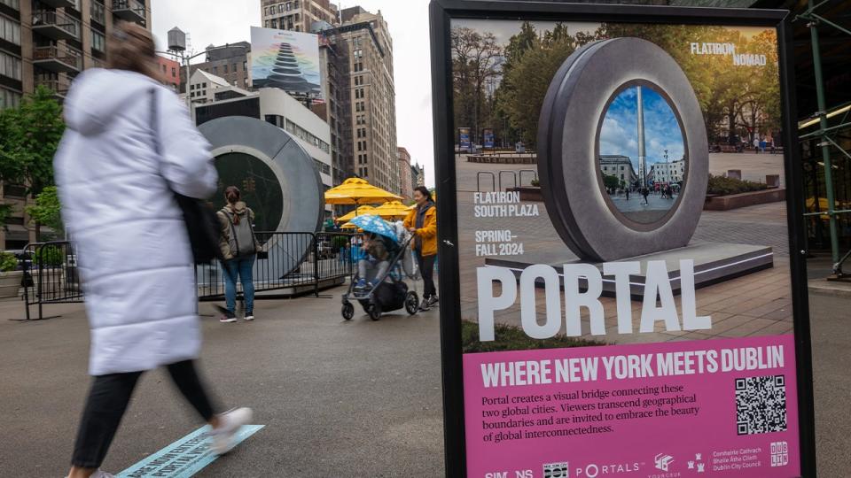 <div>People pass a video "Portal" art installation connecting New York City and Dublin, Ireland via a 24/7 video livestream which sits temporarily shut down in the Flatiron Plaza on May 15, 2024 in New York City. The "Portal", a Flatiron NoMad Partnership, has been temporarily shut down after two weeks for "inappropriate behavior" from a small group of individuals on both sides of the Atlantic. The livestream will once again be opened by the end of the week. (Photo by Spencer Platt/Getty Images)</div>