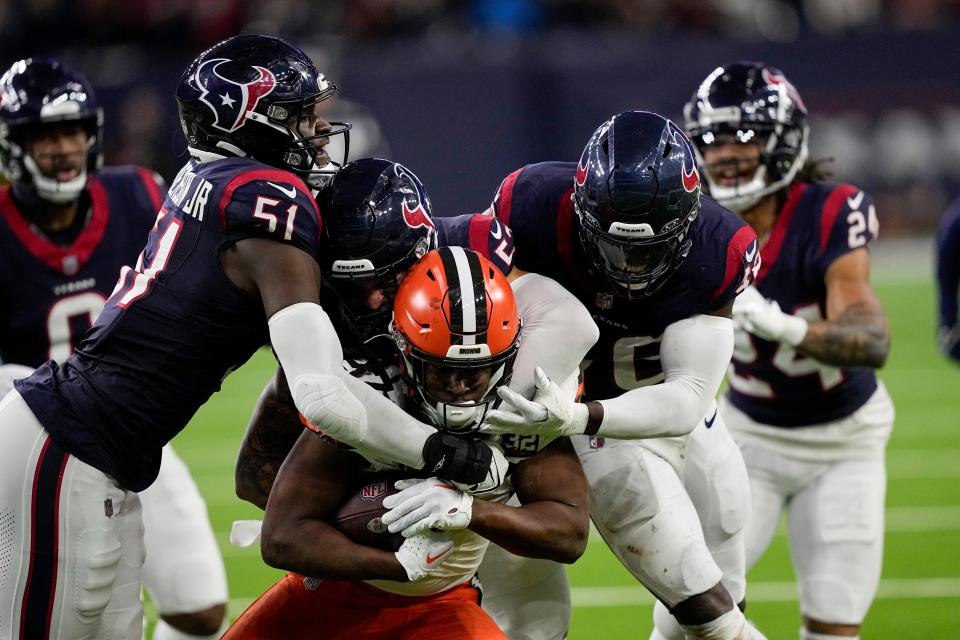 Cleveland Browns running back Kareem Hunt is tackled by the Houston Texans on Saturday in Houston.