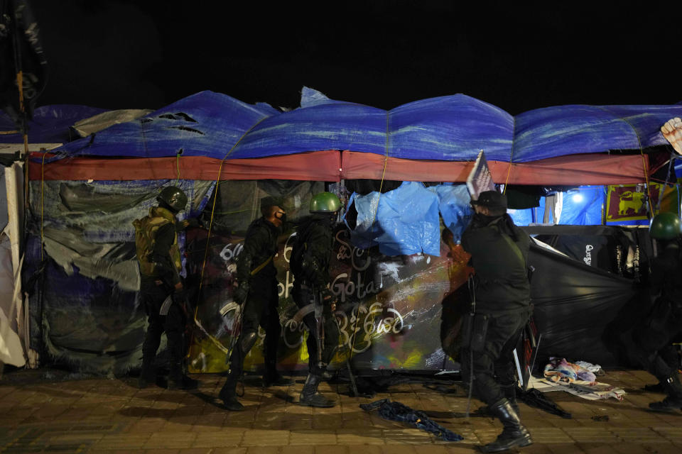 Army soldiers remove tents from the site of a protest camp outside the Presidential Secretariat in Colombo, Sri Lanka, Friday, July 22, 2022. (AP Photo/Rafiq Maqbool)