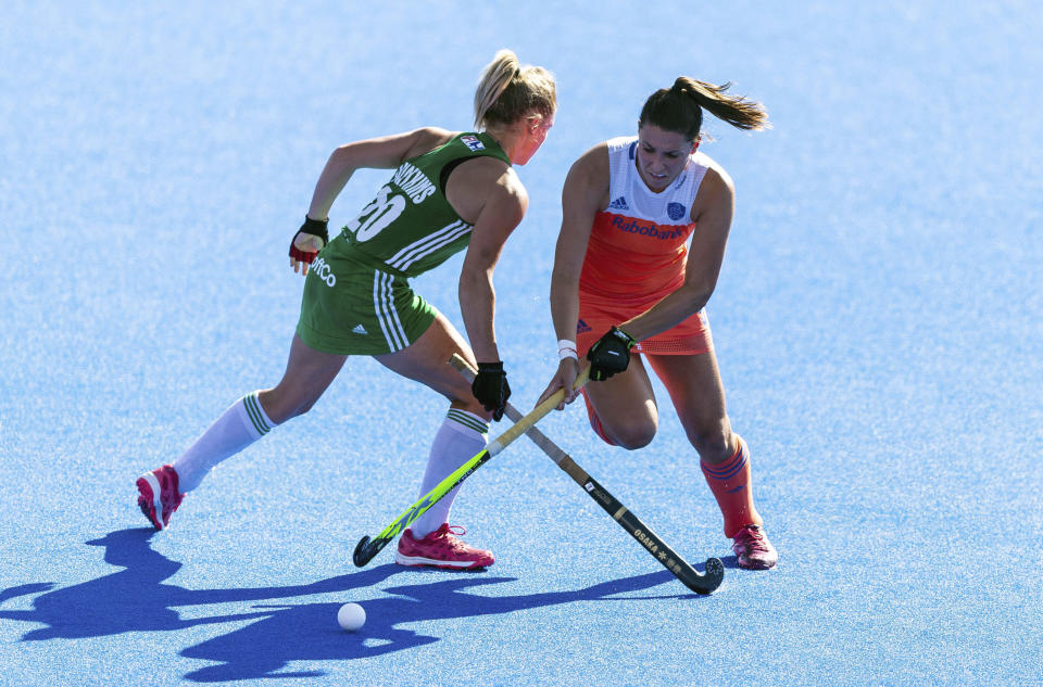 Netherlands' Malou Pheninckx , rightand Ireland's Chloe Watkins vie for the puck during the Women's Hockey World Cup Final match between the Netherlands and Ireland, at The Lee Valley Hockey and Tennis Centre, in London, Sunday Aug. 5, 2018. (Paul Harding/PA via AP)
