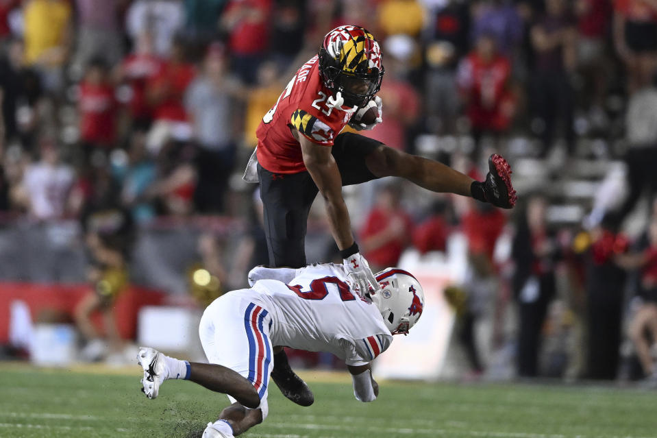 Maryland safety Beau Brade, top, intercepts a pass and is tackled by SMU's Moochie Dixon in the first half of an NCAA college football game, Saturday, Sept. 17, 2022, in College Park, Md. (AP Photo/Gail Burton)