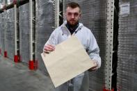 CEO of the "Re-leaf Paper" project Frechka shows a paper bag, partially made of fallen tree leaves, at the Zhytomyr Cardboard Factory in Zhytomyr