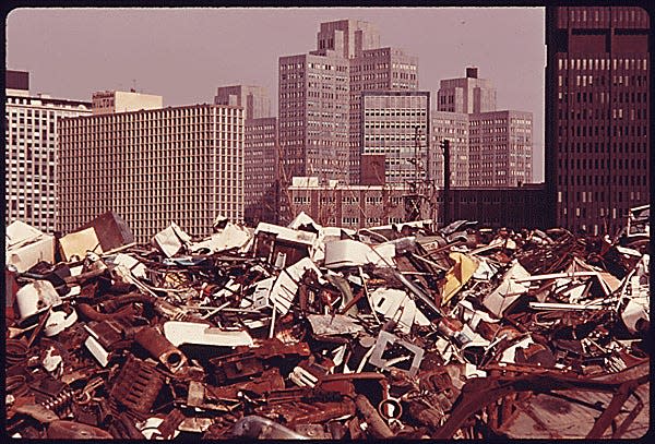 Pittsburgh JUNKYARD ACROSS THE MONONGAHELA RIVER CONTRASTS WITH THE MODERN OFFICE BUILDINGS AND SEEMS TO BRING THE TWO LOCATIONS CLOSER THAN REALITY BECAUSE OF THE USE OF A TELEPHOTO LENS. THE URBAN RENEWAL RENAISSANCE PROGRAM WAS BEGUN IN THE CITY IN THE EARLY 1950'S