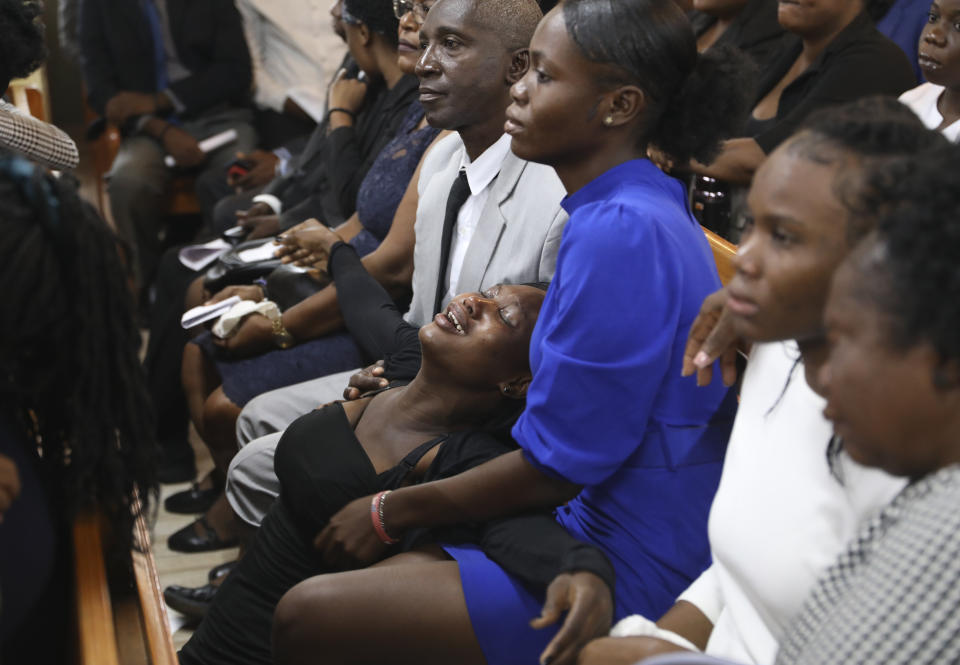 People attend the funeral service for mission director Judes Montis, killed by gangs alongside two of his U.S. missionary members, in Port-au-Prince, Haiti, Tuesday, May 28, 2024. The service also honored the lives of Davy and Natalie Lloyd, a married couple in their early 20s who were with Montis when gunmen ambushed them on Thursday night, May 23, as they left a youth group activity held at a local church. (AP Photo/Odelyn Joseph)