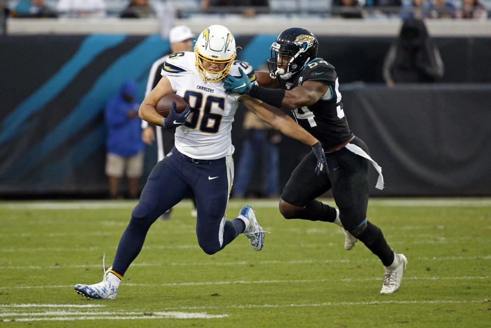 Los Angeles Chargers tight end Hunter Henry (86) tries to get away from Jacksonville Jaguars linebacker Donald Payne after a reception during the first half of an NFL football game, Sunday, Dec. 8, 2019, in Jacksonville, Fla. (AP Photo/Stephen B. Morton)