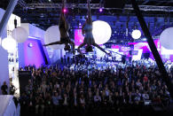 Dancers on ropes perform at the Via Motors stand.