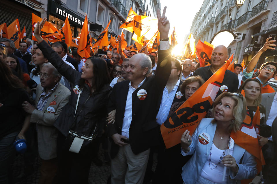 Rui Rio, leader of the Social Democratic Party, center, gestures during an election campaign action in downtown Lisbon Friday, Oct. 4, 2019. Portugal will hold a general election on Oct. 6 in which voters will choose members of the next Portuguese parliament. (AP Photo/Armando Franca)