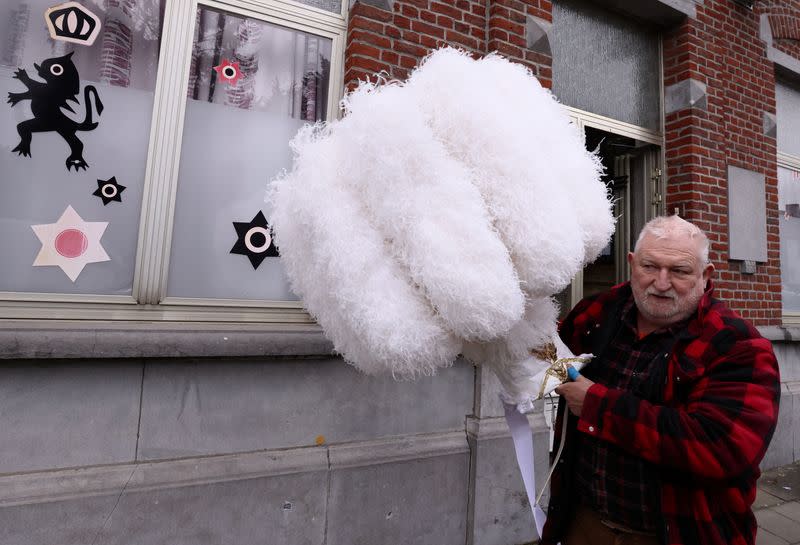 Daniel Masse, a "Gilles of Binche" performer collects ostrich feather hats at the workshop of Louis Kersten in Binche