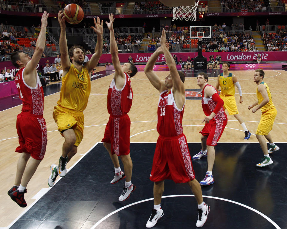 LONDON, ENGLAND - AUGUST 06: Australia's Matt Nielsen (2nd L) goes up to score against Russia during their men's preliminary round Group B basketball match on Day 10 of the London 2012 Olympic Games at the Basketball Arena on August 6, 2012 in London, England. (Photo by Sergio Perez - IOPP Pool /Getty Images)
