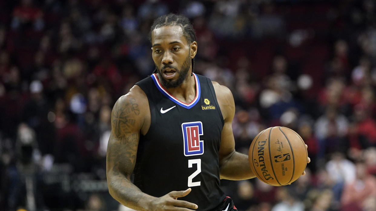 Los Angeles Clippers' Kawhi Leonard (2) brings the ball up the court against the Houston Rockets during the first half of an NBA basketball game Wednesday, Nov. 13, 2019, in Houston. (AP Photo/David J. Phillip)