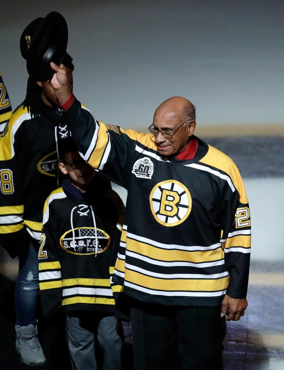 Former Boston Bruins forward Willie O’Ree tips his hat as he is honored prior to the first period of an NHL hockey game against the Montreal Canadiens in Boston, Wednesday, Jan. 17, 2018. (AP Photo/Charles Krupa, File)