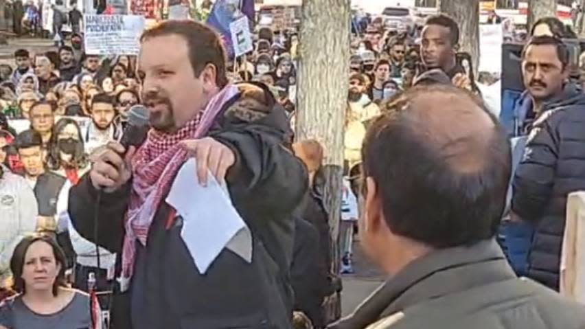 Wesam Cooley, who goes by the name Wesam Khaled, addresses the crowd at a Justice for Palestinians protest in downtown Calgary on Sunday, Nov. 5. He was charged shortly afterward for causing a disturbance with 'hate motivation' applied to the charge.