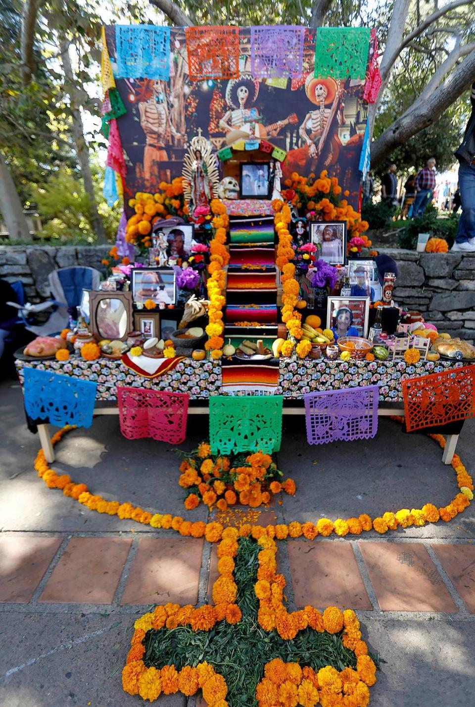 The Dia de los Muertos festival was held at the Mission Plaza on Saturday. This altar, or “ofrendas” (meaning offering), was created by Corina Guzman of Paso Robles, with the help of her husband and family. She said they create the altar every years but decided to bring it out in the public this year, “for everyone to see.”