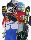 Winner Ted Ligety of the U.S. (R) hugs third-placed France's Alexis Pinturault after the second run of the men's alpine skiing giant slalom event in the Sochi 2014 Winter Olympics at the Rosa Khutor Alpine Center February 19, 2014. REUTERS/Mike Segar (RUSSIA - Tags: OLYMPICS SPORT SKIING)