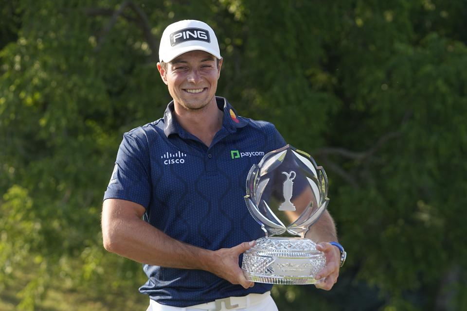 Viktor Hovland, of Norway, holds the trophy after winning the Memorial golf tournament, Sunday, June 4, 2023, in Dublin, Ohio. (AP Photo/Darron Cummings)