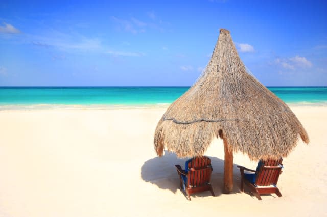 Grass hut on tropical beach