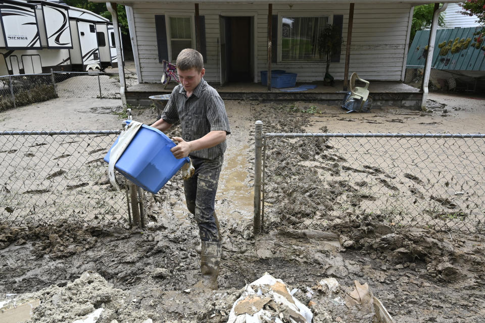 Members of the local Mennonite community remove mud filled debris from homes following flooding at Ogden Hollar in Hindman, Ky., Saturday, July 30, 2022. (AP Photo/Timothy D. Easley)