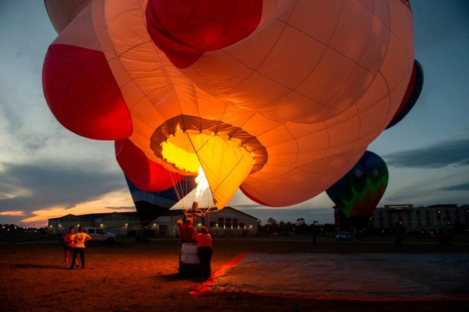 A hot air balloon pilot fires the burners inside “Laska the Unicorn”, a unicorn shaped hot air balloon, during the Gulf Coast Hot Air Balloon Festival at OWA in Foley, Alabama on Thursday, May 4, 2023.