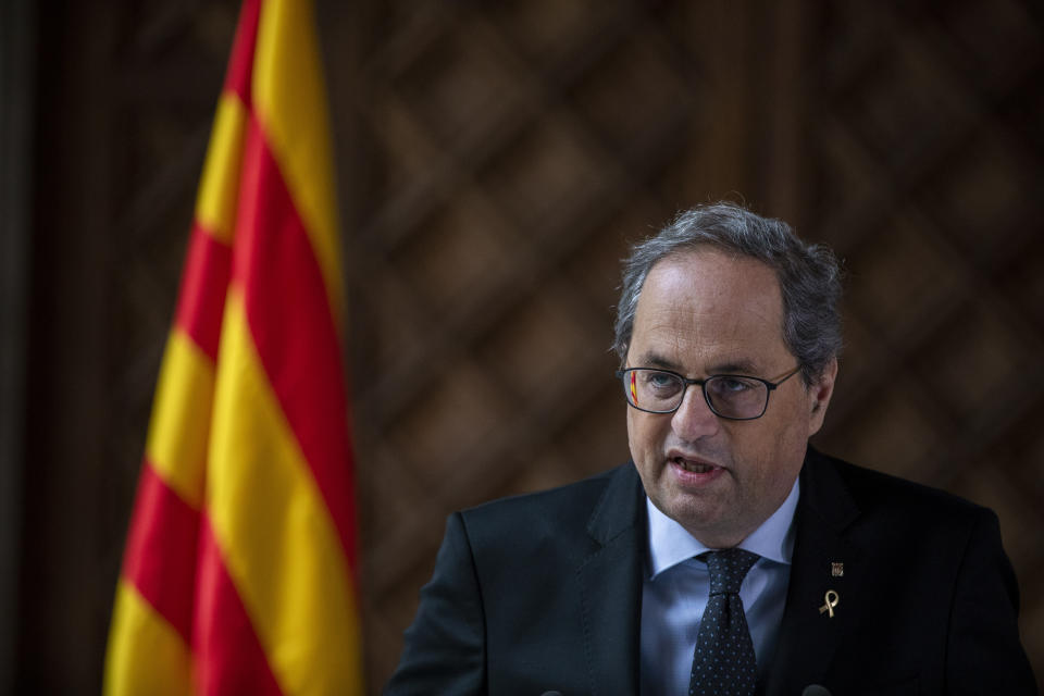 Catalan regional president Quim Torra speaks at the Palace of the Generalitat, the headquarter of the Government of Catalonia, in Barcelona, Spain, Wednesday Jan. 29, 2020. The regional president of Spain's conflict-riven region of Catalonia said Wednesday that he will soon call a snap election amid splits in his government's unity. (AP Photo/Emilio Morenatti)