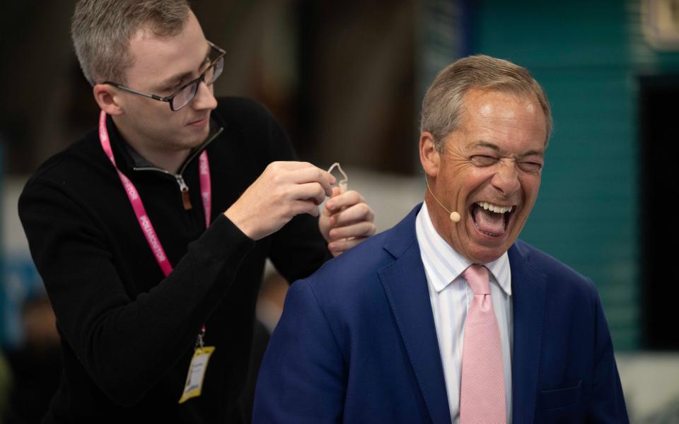 Nigel Farage prepares for a TV appearance during day two of Conservative Party conference in Manchester