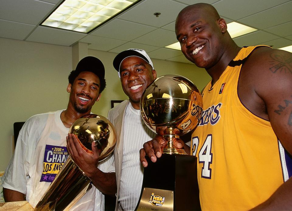 Bryant and O'Neal pose with another Lakers legend, Magic Johnson, after they won the 2000 NBA Championship against the Indiana Pacers at the Staples Center in L.A. 