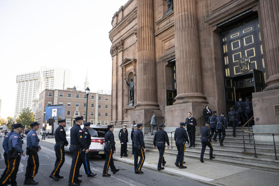 Law enforcement officers attend a viewing for officer Richard Mendez at the Cathedral Basilica of Saints Peter and Paul in Philadelphia, Tuesday, Oct. 24, 2023.Mendez was shot and killed, and a second officer was wounded when they confronted people breaking into a car at Philadelphia International Airport, Oct. 12, police said. (AP Photo/Joe Lamberti)