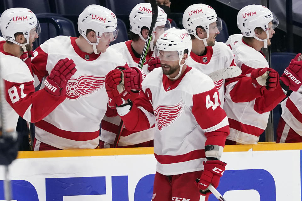 Detroit Red Wings center Luke Glendening (41) is congratulated after scoring a goal against the Nashville Predators in the second period of an NHL hockey game Saturday, Feb. 13, 2021, in Nashville, Tenn. (AP Photo/Mark Humphrey)