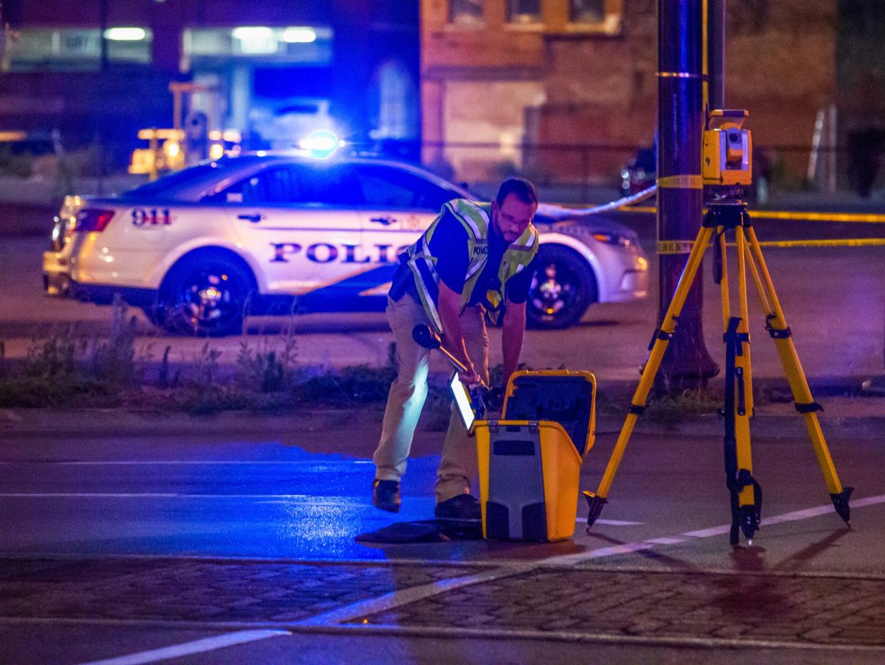Police officers investigate the scene on Second Street and Market Street where a driver struck pedestrians in downtown Louisville on July 5, 2022. A man was taken into custody and charged with impairment and three adults and one child were taken to the UofL and Norton Children's Hospital.