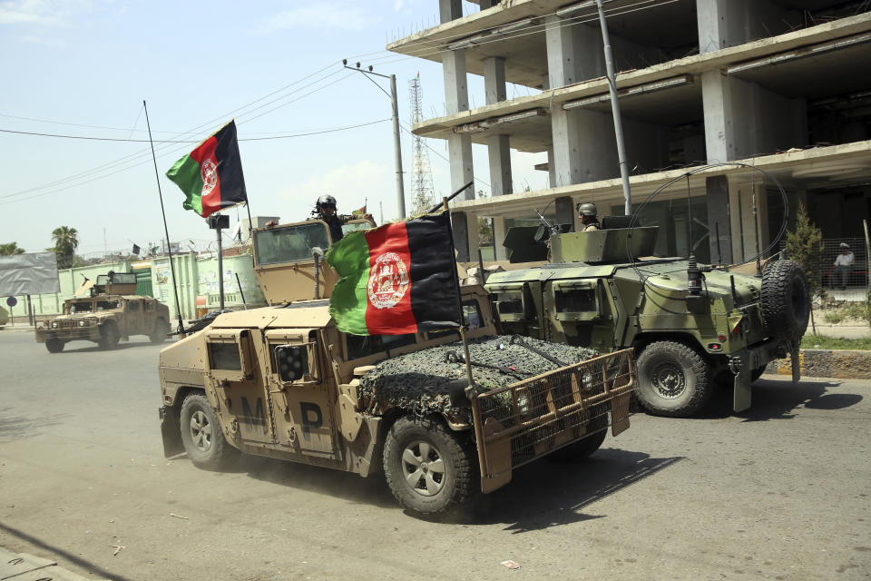 File - In this Monday, Aug. 3, 2020 file photo, Afghan security personnel gather near a prison after an attack in the city of Jalalabad, east of Kabul, Afghanistan. Afghanistan has been at war for more than 40 years, first against the invading Soviet army that killed more than 1 million people, then feuding mujahedin groups in a bitter civil war followed by the repressive Taliban rule and finally the latest war that began after the 2001 U.S.-led coalition invasion that toppled the Taliban government. (AP Photo/Rahmat Gul, File)