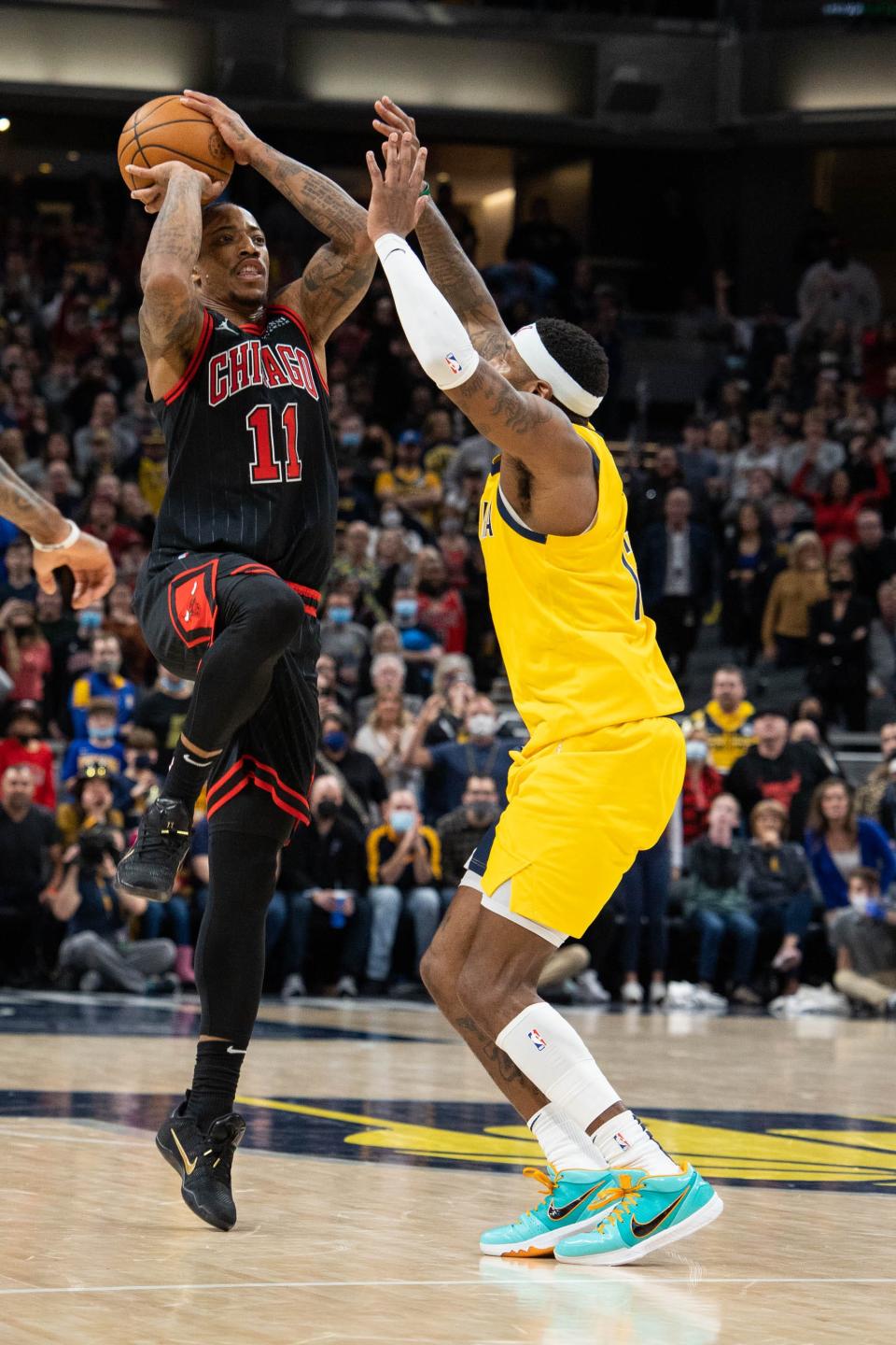 Dec 31, 2021; Indianapolis, Indiana, USA; Chicago Bulls forward DeMar DeRozan (11) shoots the game winning three pointer while Indiana Pacers forward Torrey Craig (13) defends in the second half at Gainbridge Fieldhouse. Mandatory Credit: Trevor Ruszkowski-USA TODAY Sports