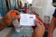 A fighter from Libyan forces allied with the U.N.-backed government holds a receipt left behind Islamic State militants in Sirte, Libya. REUTERS/Ismail Zitouny