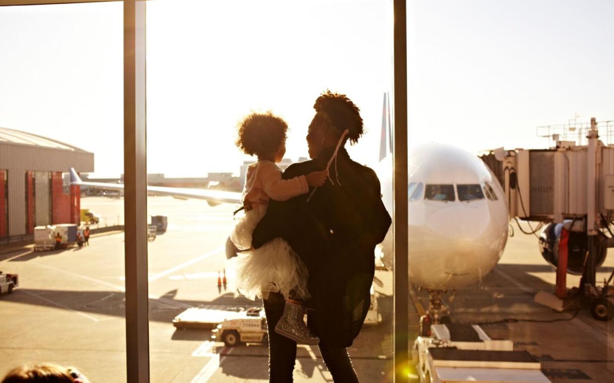 mother and daughter at airport - mother's day travel gift guide